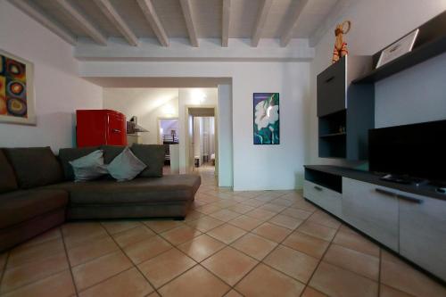 a living room with a couch and a flat screen tv at Apt 6 Borgo Lago di Garda in Lonato del Garda