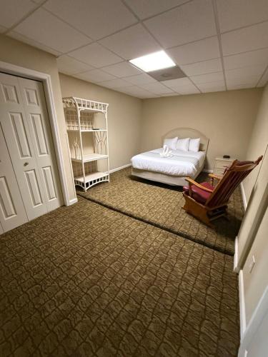 a room with a bed and a chair and a door at Boardwalk Beach Resort in Myrtle Beach