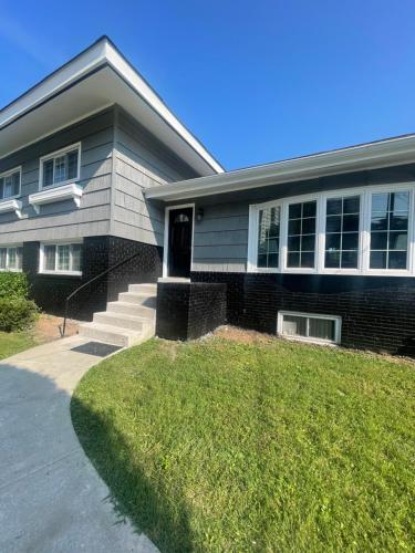 a house with a grass yard in front of it at Entire 5 Bedrooms Home near DC and Metro in Silver Spring
