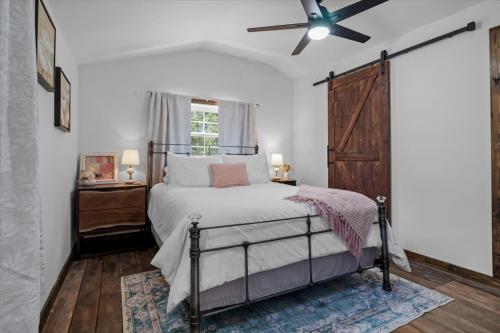 a bedroom with a bed and a ceiling fan at The Heartwood Hideaway-Charming Cabin Getaway-Trails, Creek, and Starry Nights in Primm Springs