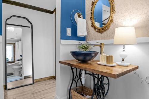 a bathroom with a sink and a mirror at The Heartwood Hideaway-Charming Cabin Getaway-Trails, Creek, and Starry Nights in Primm Springs