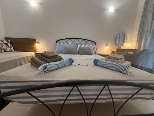 a bed with two pillows on top of it at Deda Apartments in Livadia