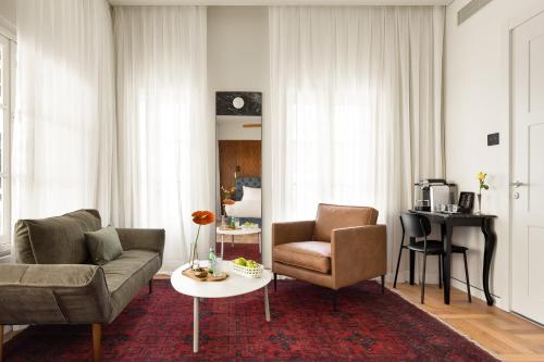 a living room with a couch and two chairs and a table at Hotel RECEPTION in Tel Aviv