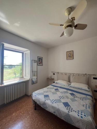 a bedroom with a bed and a ceiling fan at camere Rosignoli in Assisi