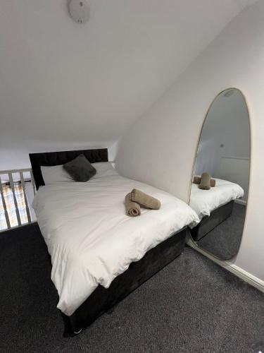 a bedroom with a bed with a mirror on it at Stylish Cozy 5-Apartments - Birmingham Central in Birmingham