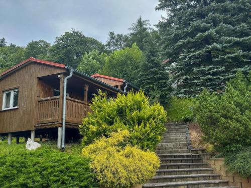 a staircase leading up to a house with trees at Selský Dvůr Perštejn in Pürstein