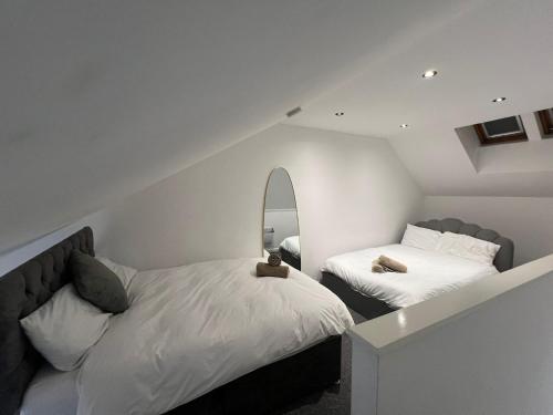 a bedroom with two beds and a mirror at Stylish Cozy 5-Apartments - Birmingham Central in Birmingham