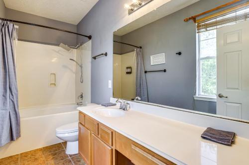 a bathroom with a sink and a toilet and a mirror at Fish and Hike Pet-Friendly Humble Home with Yard in Humble