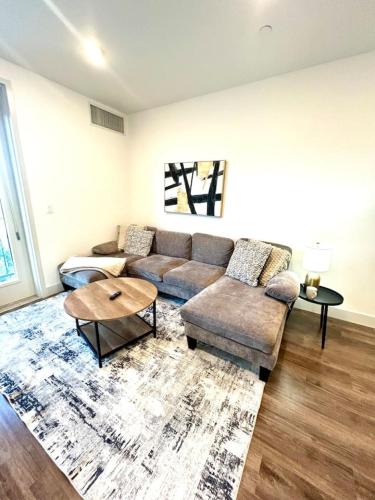a living room with a couch and a table at Beehive Escape -Salt Lake City in Salt Lake City