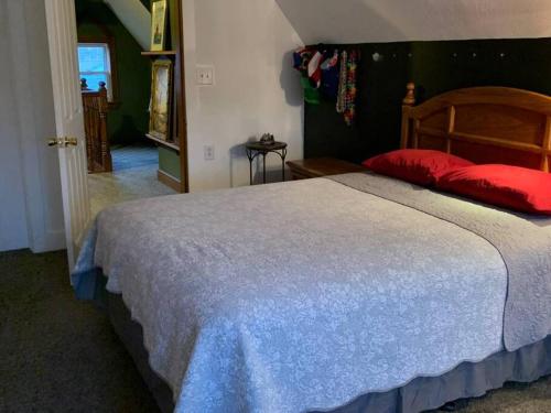 a bedroom with a large bed with a red pillow at Greenwood Mansion-country Living in Greenwood