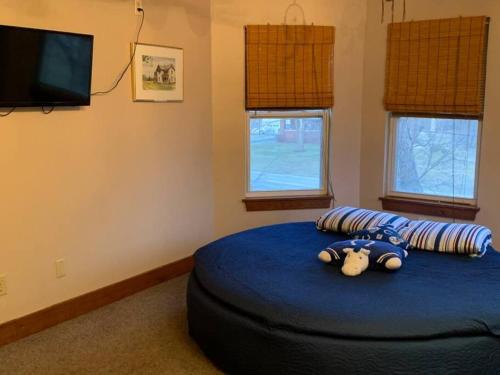 a teddy bear laying on a bed in a bedroom at Greenwood Mansion-country Living in Greenwood