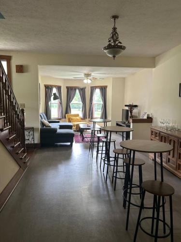 a living room with tables and chairs and a couch at Greenwood Mansion-country Living in Greenwood