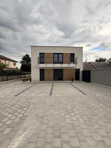 a large building with a balcony on top of it at Dream Premium Apartman in Mosonmagyaróvár