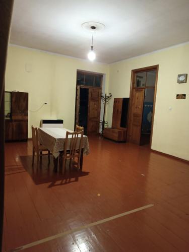 an empty room with a table and chairs in it at Great Home in Akhaltsikhe