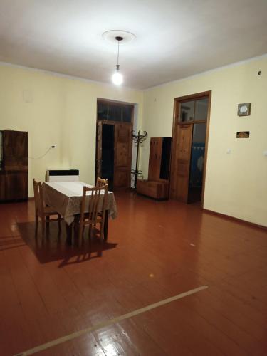 an empty room with a table and chairs in it at Great Home in Akhaltsikhe