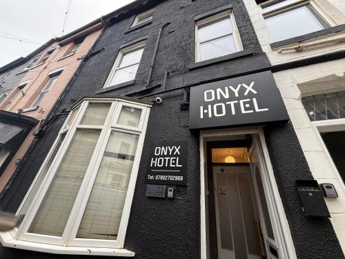 a building with a hotel sign on the side of it at ONYX Hotel Blackpool in Blackpool