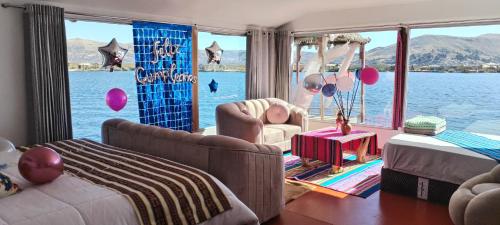 a living room with a view of the water at Titicaca Sariri Lodge in Puno