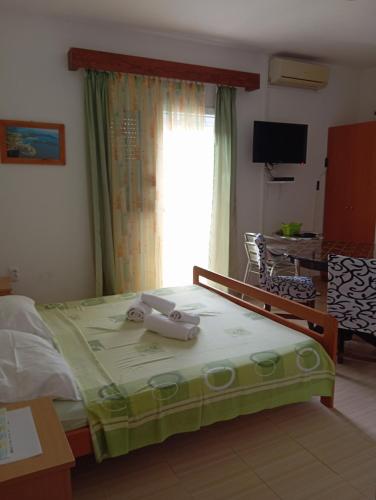 a bedroom with a large bed with a window at Apartment Stella in Murter