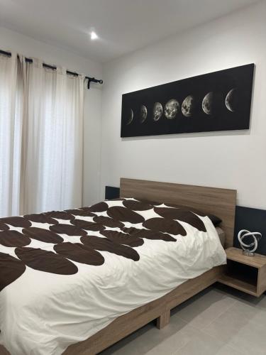 a bedroom with a bed with a black and white comforter at SUPERBE Villa PISCINE moderne - Cap brun - plage de Toulon in Toulon