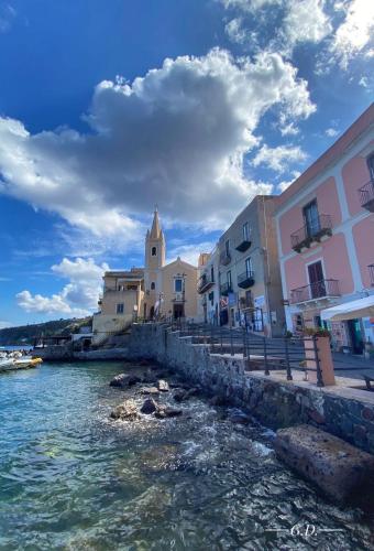 a group of buildings next to a body of water at Via Roma 55 in Lipari