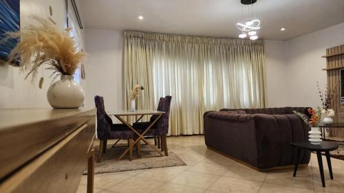 a living room with a couch and a table at the luxury Apartment in Lekki