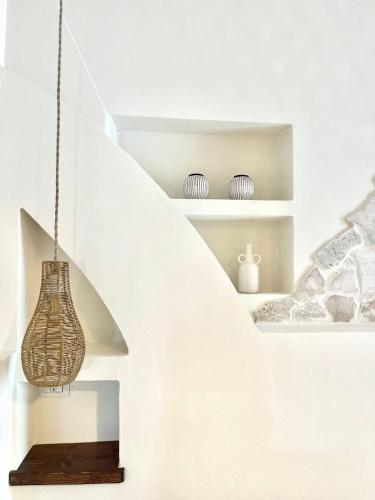 a room with a staircase with a hanging light fixture at Dimore Mida in Brindisi