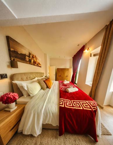 a bedroom with a bed with a red and white blanket at OneLuxStay near Antwerp Central in Antwerp