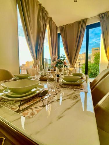 a dining table with plates and glasses on it at OneLuxStay near Antwerp Central in Antwerp