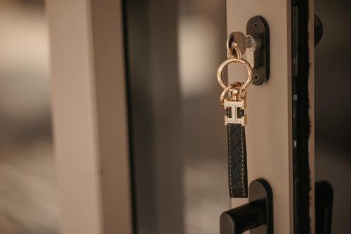 a key to a door with a chain on it at GkF Luxury Villas in Naxos Chora