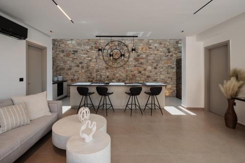 a living room with a couch and a kitchen at GkF Luxury Villas in Naxos Chora