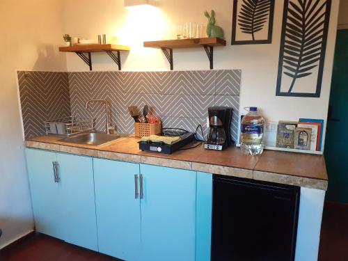 a kitchen with a sink and a counter top at Colibri Récif - 2 min from beach - Pool & Calm in Peñita de Jaltemba