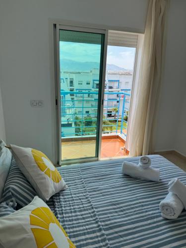 a bedroom with a bed with a view of a balcony at Ático con vistas en Cabo in Cabo Negro