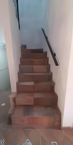 a stairway with wooden steps in a room at C10 Casa colmena 3 minutos playa alberca 2 rec. in Peñita de Jaltemba