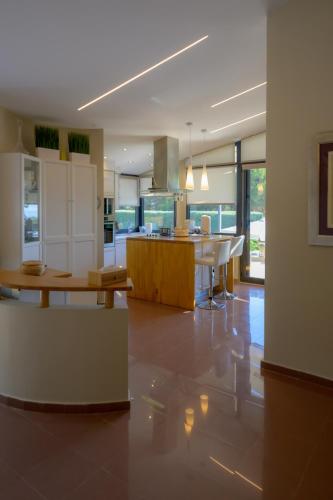 a kitchen with a table and a dining room at Mytilini luxury pool VILLA AMIKA in Mytilini