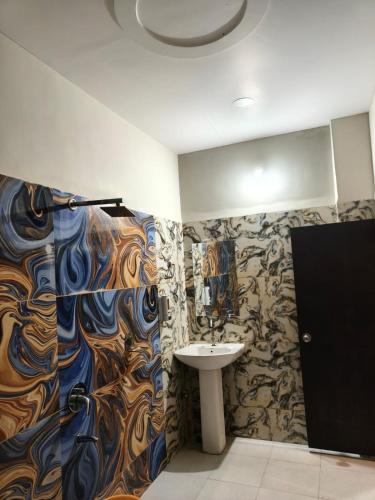 a bathroom with a sink and a shower at Hotel Anmol and Resort in Ghāt Bilod