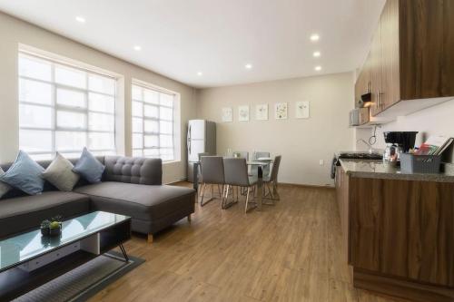a living room with a couch and a table and a kitchen at 501 Zocalo 3Bdrm 2bath Rooftop in Mexico City