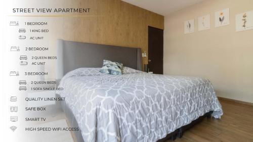 a bedroom with a bed with a white comforter at 501 Zocalo 3Bdrm 2bath Rooftop in Mexico City
