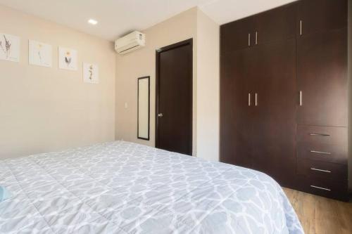 a bedroom with a large bed and wooden cabinets at 501 Zocalo 3Bdrm 2bath Rooftop in Mexico City