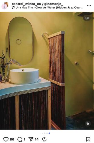 a bathroom with a sink and a mirror at Minkanta Central Hostel in Minca