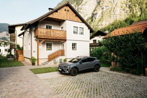a small car parked in front of a house at Hallstatt-Haus Elfriede in Hallstatt
