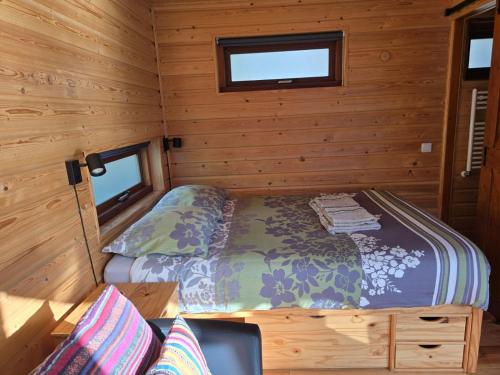 a small bedroom with a bed in a wooden cabin at Mar&Mar Houseboat Studio in Amsterdam