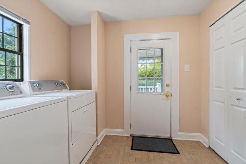 a kitchen with a sink and a white door at # Stay At Our Tasteful, Private, & Elegant Abode # in Devon