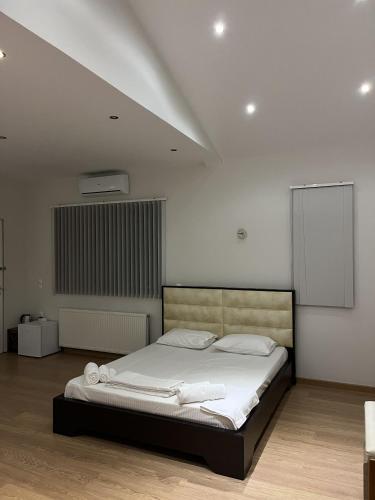 a bedroom with a large bed with white sheets at Zografos Studios Zacharo Zakharo in Zakharo