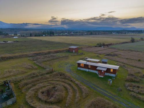 an aerial view of a house in a field at Frontier Farmhouse-sauna &ht in Port Angeles