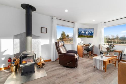 a living room with a wood stove in a room at Frontier Farmhouse-sauna &ht in Port Angeles