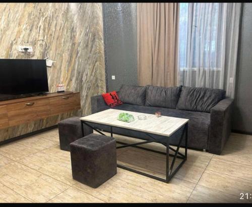 a living room with a couch and a coffee table at Apart erevan 12 