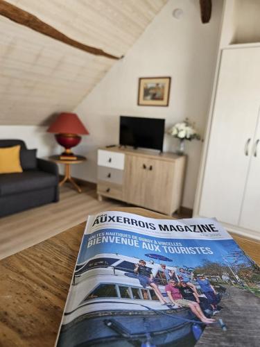 a magazine sitting on a table in a living room at AuxCerfs - Église Saint-Eusebe in Auxerre