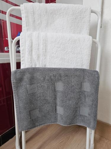 a towel rack on a chair with towels on it at AuxCerfs - Église Saint-Eusebe in Auxerre