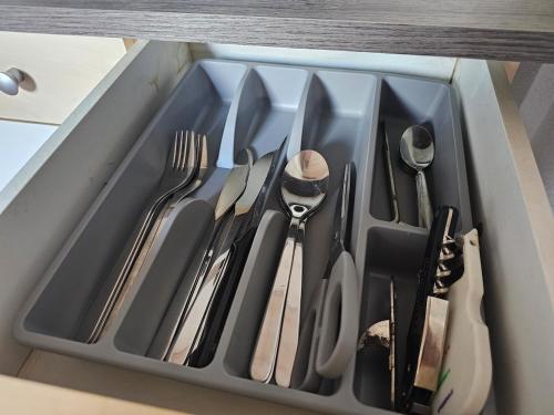 a tray filled with utensils in a drawer at AuxCerfs - Église Saint-Eusebe in Auxerre