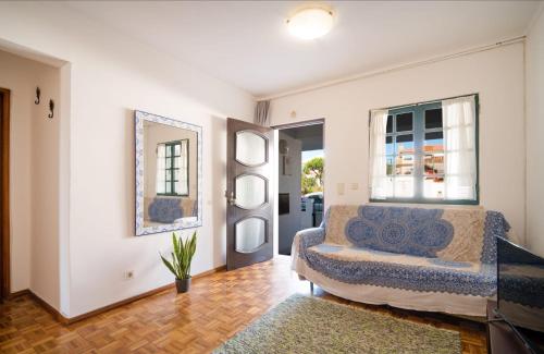 a living room with a bed and a mirror at Apartment Wolf in Lourinhã